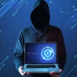 medium-shot-man-with-hoodie-holding-laptop-e1646646997479-1-696x465